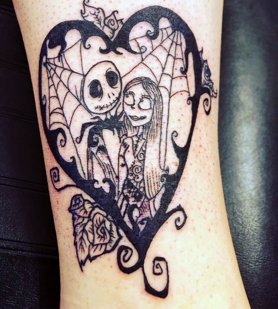 Nightmare Before Christmas Jack and Sally in a heart with webs tattoo. John at Rogsy Tattoo Studio.