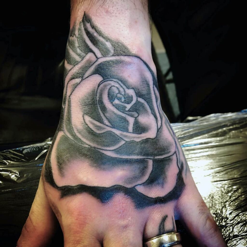 Rose hand tattoo. John at Rogsy Tattoo Studio.