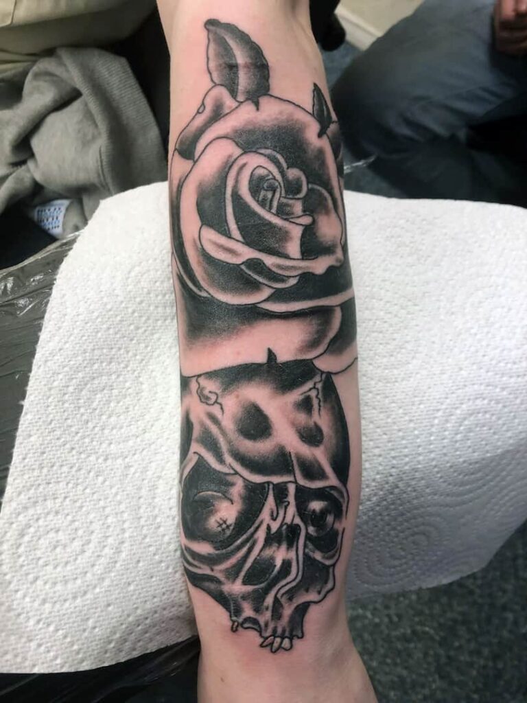 Rose and skull tattoo. Lower arm. John at Rogsy Tattoo Studio.