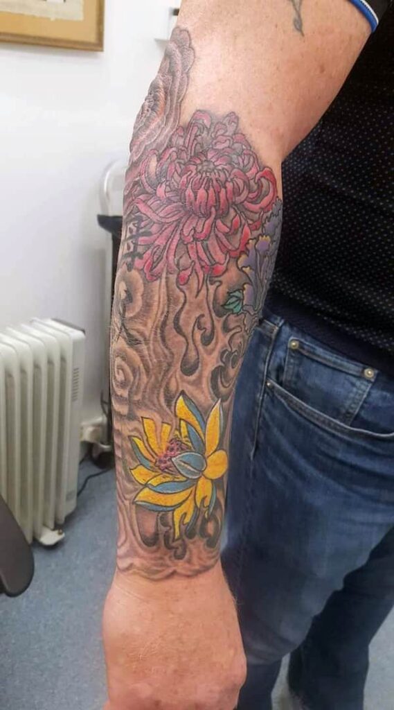 Chinese-style flower artwork, on lower arm. John at Rogsy Tattoo Studio.
